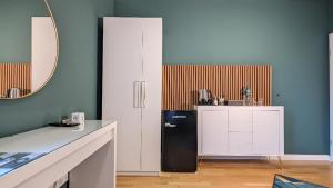柏林3 ROOMS - Zimmervermietung nähe Flughafen BER - gratis WLAN, Parken & Netflix的厨房配有黑色冰箱和台面