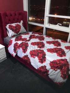 迪拜Paz Holiday Luxurious Space的一间卧室,床上有红色玫瑰