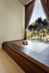 日惹Riss Hotel Malioboro的一张位于带大窗户的房间内的床铺