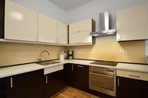 科沃布热格迪优内度假公寓的厨房配有白色橱柜和水槽