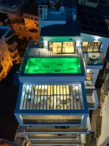 塞萨洛尼基SIGMA Luxury Apartments & Suites的享有带游泳池的大楼的顶部景致