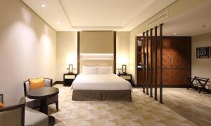 吉达Aerotel Jeddah的酒店客房,配有床、桌子和椅子