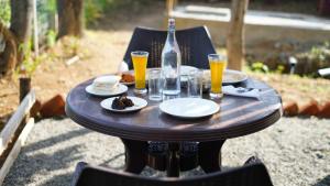 科代卡纳尔Royal Adventures的一张木桌,上面放着食物和一瓶啤酒