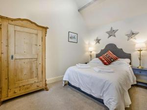 Kemble1 Bed in Cirencester 57684的卧室配有一张大床,墙上挂着两颗星