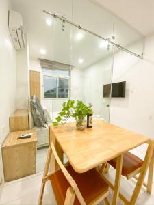 胡志明市Aloha House Apartment的一间带木桌和沙发的用餐室