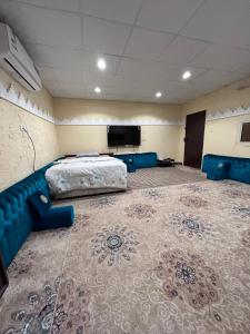 乌姆莱季استديو البركه-Al Baraka Studio的客房设有床、沙发和电视。