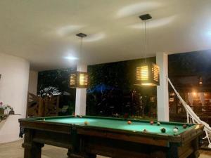 瓜拉派瑞Espaço Hale Kai的客厅配有一张台球桌和两盏灯
