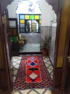 马拉喀什HOTEL EL AMAL的进入地板上带地毯的房间的入口