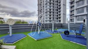 吉隆坡One Cochrane Premier Suites by BlueBanana near TRX, IKEA Cheras & MyTown的一个带时钟和一些健身器材的阳台