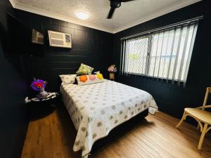 North WardHoliday at Henry St West End, Townsville QLD 3 night min的一间黑色卧室,配有床和窗户