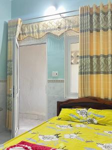 广义Homestay Xuân Mai的一间卧室设有一张黄色的床和窗户