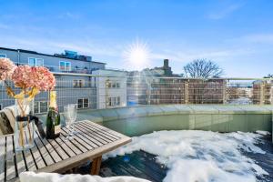 奥斯陆Top floor with balcony - Super central - 5 pax的阳台的天井上配有雪和桌子。
