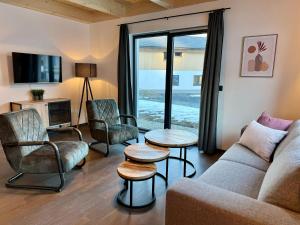 黑马戈尔Chalet in Hermagor near Nassfeld ski area的客厅配有沙发、椅子和电视