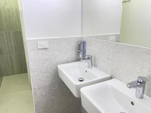 卢布尔雅那Rooms Miklošičeva的浴室设有白色水槽和镜子