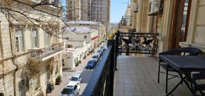 巴库Pilot hotel Baku center的阳台,可停放在城市街道上的汽车
