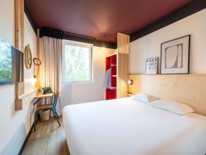 蒙特讷Greet hotel Bourg-en-Bresse Sud Montagnat的卧室设有一张白色大床和一扇窗户。