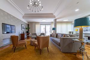 马托西纽什波尔图马尔酒店的客厅配有沙发、椅子和电视
