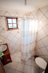 阿蒂巴亚Alameda Galu的浴室配有淋浴帘和盥洗盆。