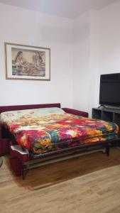 Prati di TivoLa Tana del Capriolo的一张带五颜六色的被子的床