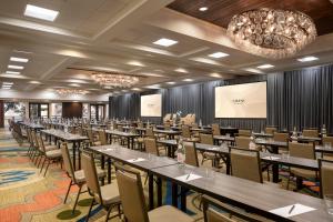 希尔顿黑德岛Omni Hilton Head Oceanfront Resort的一间会议室,配有桌椅和投影屏幕