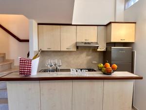 斯佩隆加Sperlonga Paradise Apartment Complex的厨房配有一碗水果和酒杯
