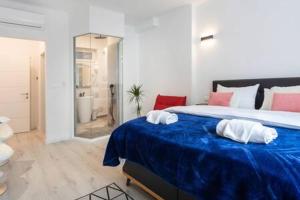 萨格勒布Lux Nest II City Apartment URBAN STAY的一间卧室配有一张大床和两条毛巾