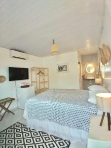 费尔南多 - 迪诺罗尼亚Maré suites的一间白色卧室,配有床和电视