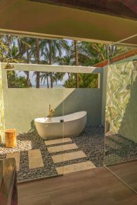 圣卡塔利娜岛Catalina's Hideaway的带浴缸和玻璃墙的浴室