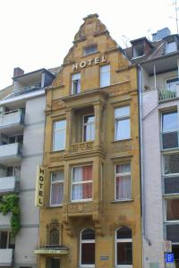 科隆杜姆欧罗巴斯赫尔霍夫酒店的黄色建筑,上面有酒店标志