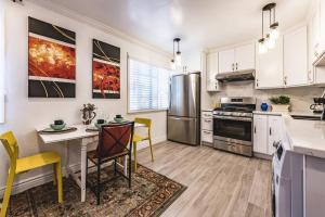East Palo AltoStanford Traveler's love & Cozy Bay trail house的厨房配有白色橱柜和桌椅