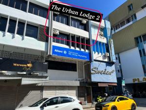 瓜拉丁加奴The Urban Lodge 2的两辆汽车停在大楼前