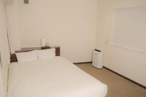 HOTEL G-CUE 大阪谷町客房内的一张或多张床位