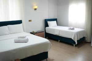 SeyhanGRAND CLOVER otel的酒店客房设有两张床和窗户。