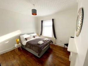 KentGravesend Spacious 2 bedroom Apartment - 2 mins to Town Centre and Train Station的一间卧室设有一张床和一个窗口