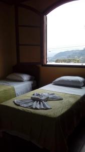 新弗里堡hostel MdeMarilia的客房内的两张床,床上有一条毛巾