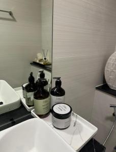 迪拜Autumn Falls, 2 Bedroom full service equipped appartement的盥洗盆旁的柜台上的浴室,配有2瓶水