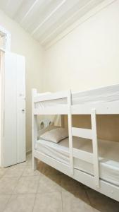 萨尔瓦多Hostel Canto Zen的白色客房内的白色双层床