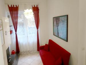 葛伦坦马勒Grottammare mon amour Kira的窗户房间里一张红色的沙发