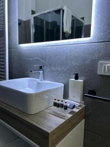 卡塞塔Zeta Rooms的浴室设有白色水槽和镜子