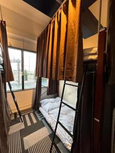 AkamineShared residence　BAR　DE‘CEBU的客房设有两张双层床和一扇窗户。