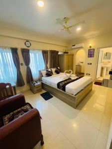 贾纳克布尔Hotel Janakpur Inn的一间带两张床和一张沙发的大卧室