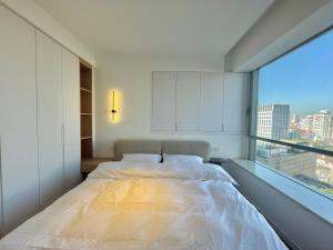 上海ZHome-Count luxury apartment的一间卧室设有一张大床和一个大窗户