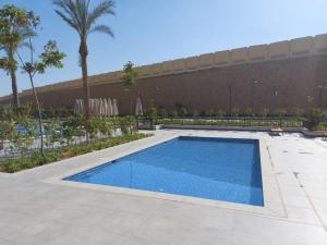 开罗Alumia Marigold Suite 3BR Apt Pool Access的大楼前的游泳池