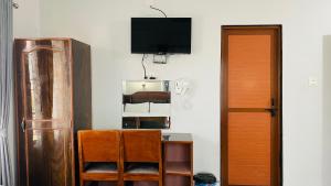 索拉哈Hotel Nepal Inn Sauraha的客房设有电视和带椅子的书桌
