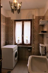 马莱斯科Casa Ezio - Piano terra的带浴缸和洗衣机的浴室。