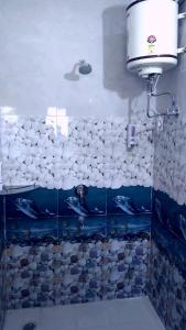 西姆拉The Breeze Homestay的浴室设有淋浴,墙上挂有鱼壁画
