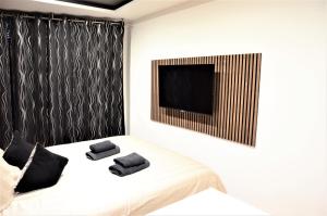 不莱梅安韦德希公寓民宿的一间卧室配有一张带两张黑色毛巾的床