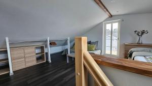 锡格蒂纳Attic floor with views over fields and sea的一间卧室设有双层床和楼梯。