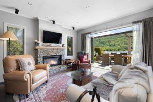 箭镇Elite Holiday Homes Queenstown - Arrowbrae的带沙发和壁炉的客厅