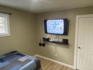 BellaireBellaire Midtown Cottage的卧室配有壁挂式平面电视。